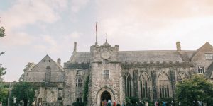 People queueing to enter the great hall beneath the clock tower